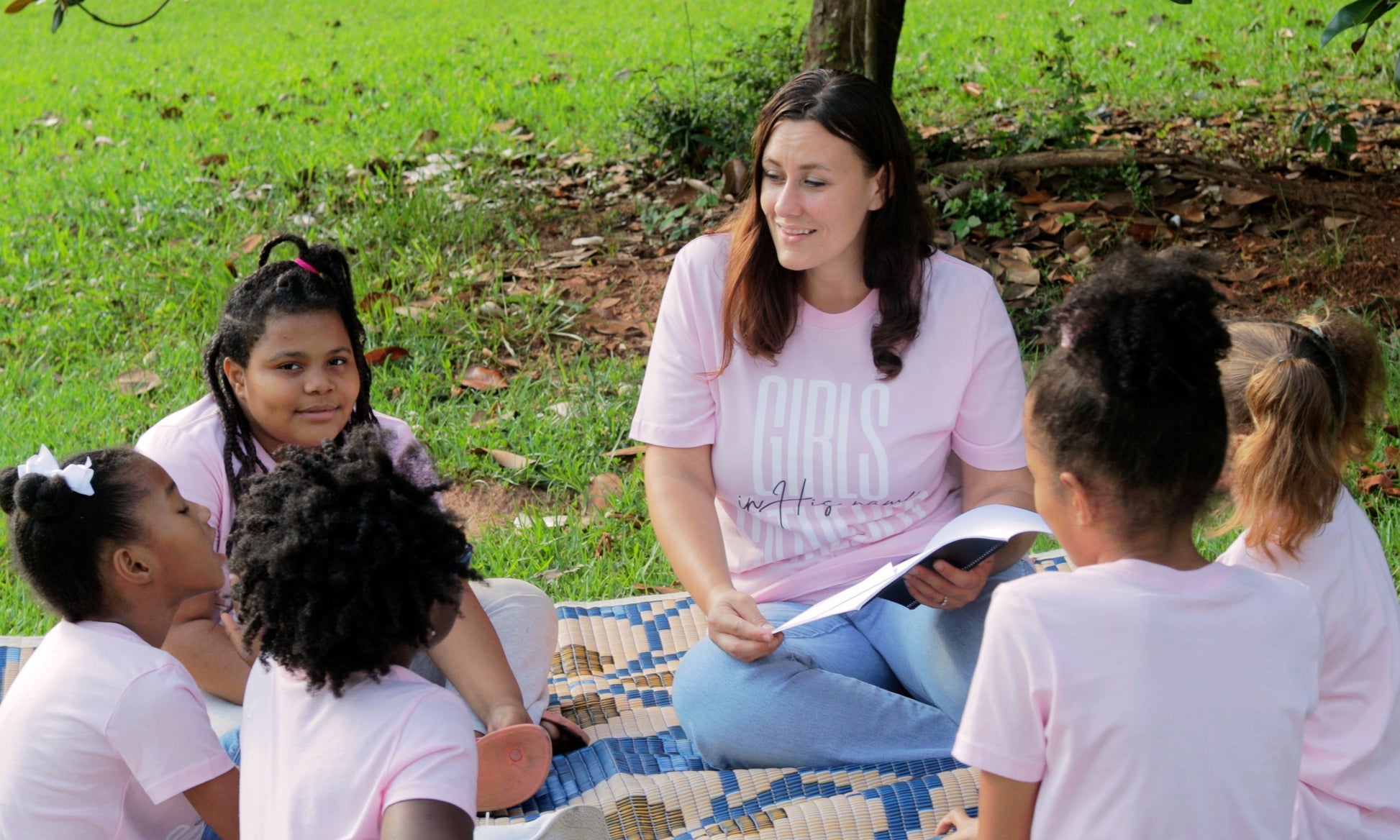 A girls small Life Group doing a Bible Study lesson outside together.