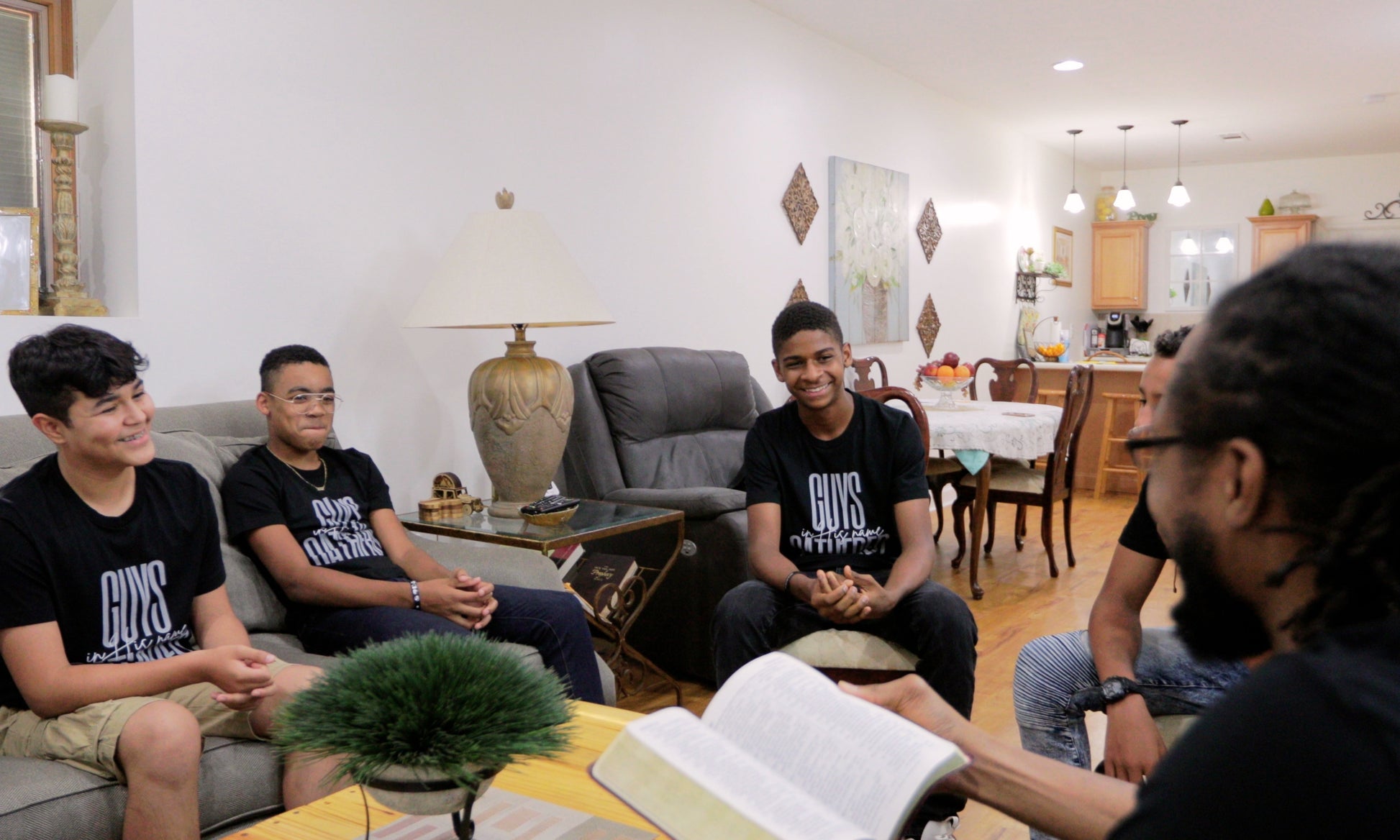 A boys small Life Group Leader and members doing a Bible Study lesson together.