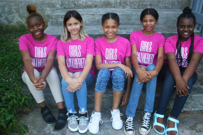 A group of tween girls wearing matching pink t-shirts for their small Christian Life Group.